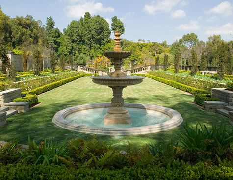 green gardens and stone fountain at the greystone mansion in beverly hills, california