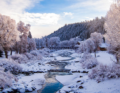 snow-filled scene of the san juan river in pagosa springs, colorado.