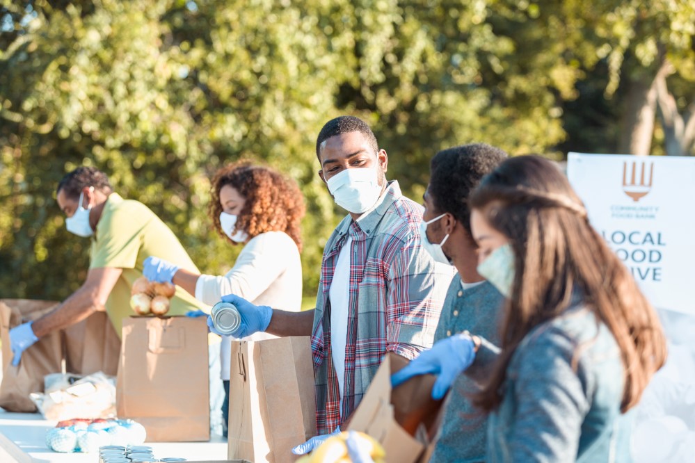 Stock photo of volunteers packaging food