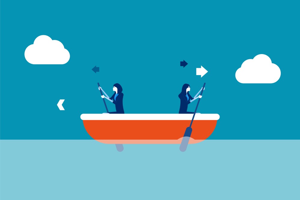 Illustration of two women in the same boat trying to row in different directions