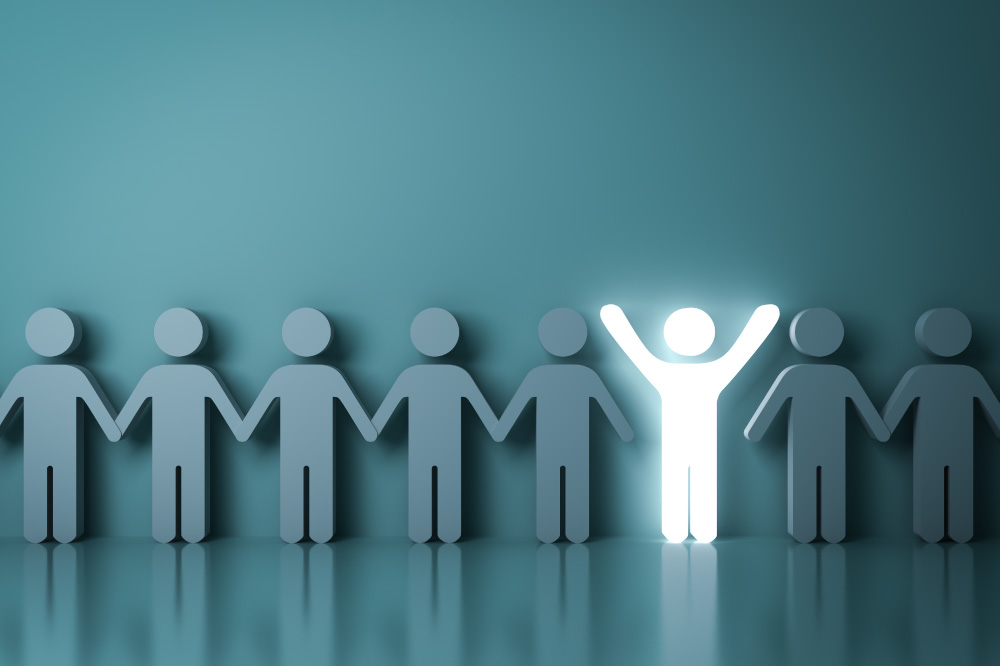 One glowing light man standing with arms wide open among other people on dark green background like 1