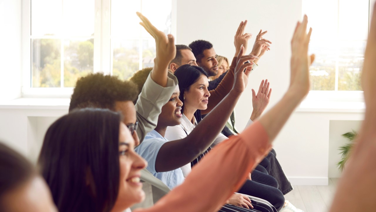 Image of young people raising their hands