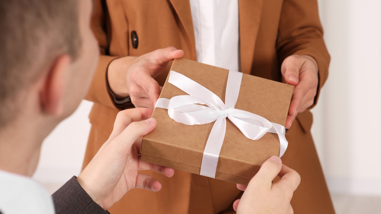 Image of a person handing someone a gift
