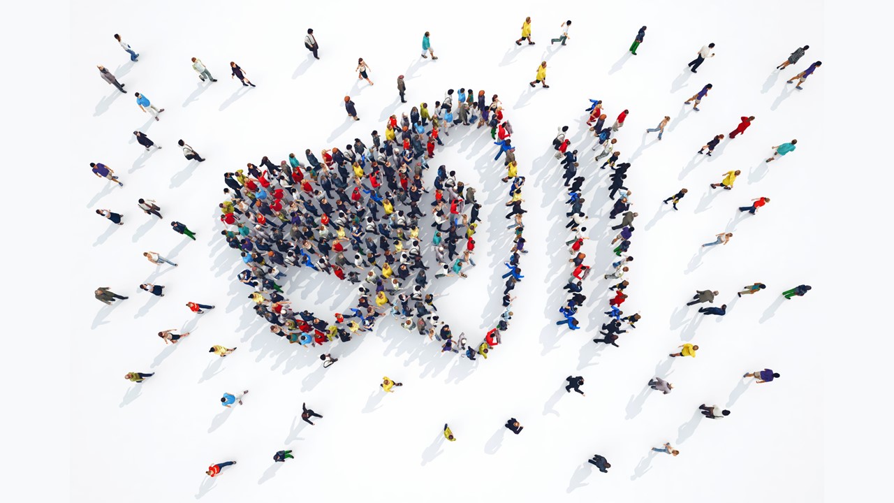 Image of people standing in the shape of a bullhorn