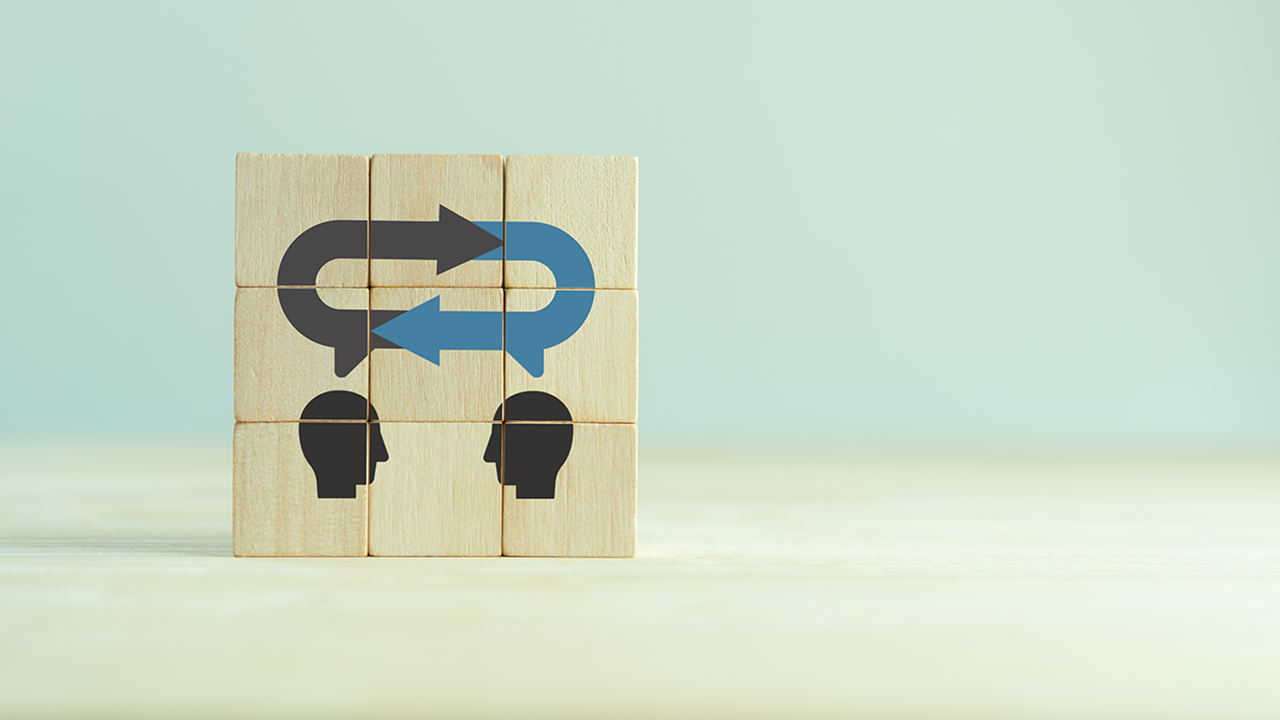 Wood blocks, stacked, with image depicting two individuals communicating