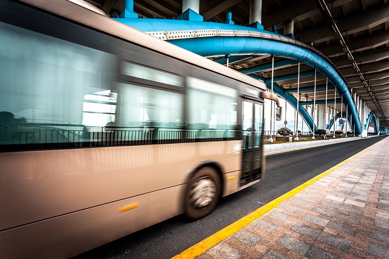 Photo of a bus driving through a bridge