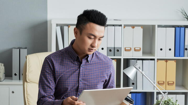 Photo of asian man using a tablet