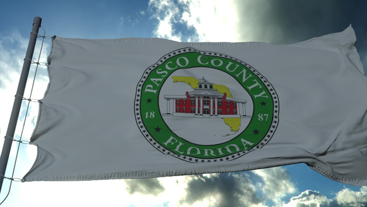 flag with official seal of pasco county florida in sunshine