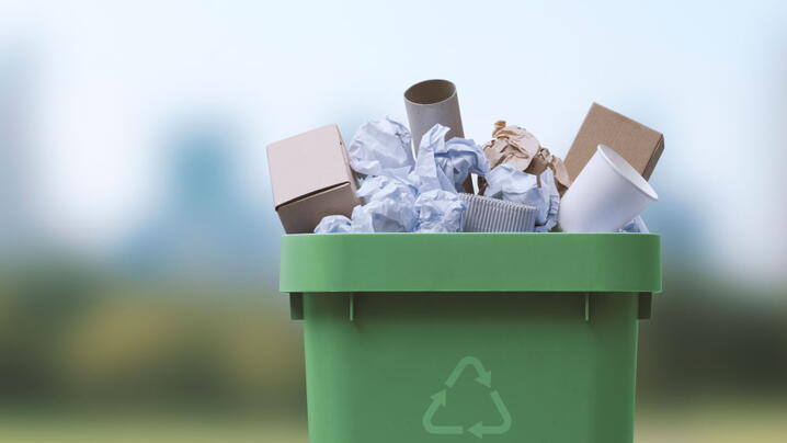 Garbage can full of paper waste