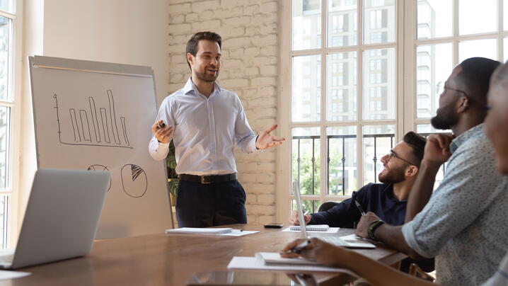 Business trainer in front of diverse team