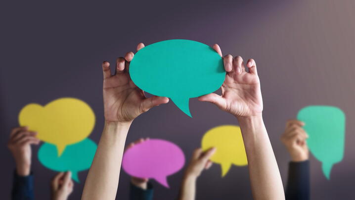 Image of hands holding speech bubbles