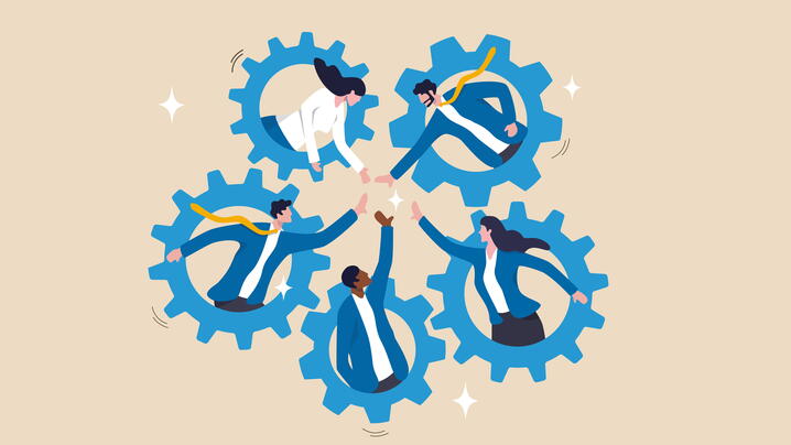 Five cogs in a circle with people holding hands in the center