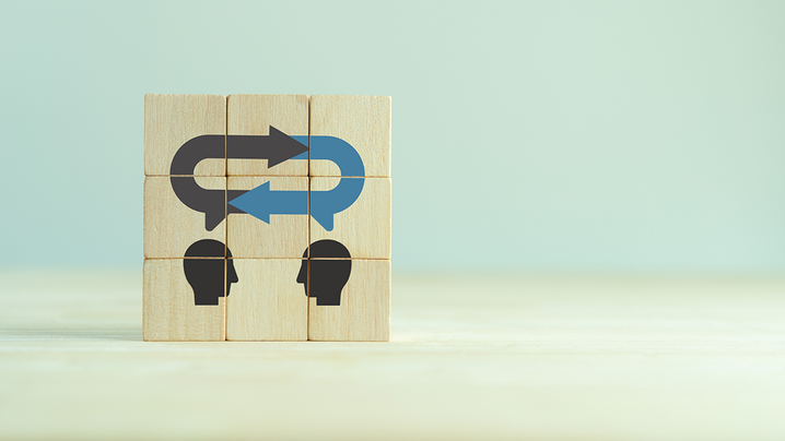 Wood blocks, stacked, with image depicting two individuals communicating