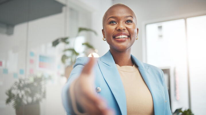 Image of person with arm extended to shake hands