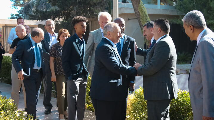 People shaking hands and meeting on a sidewalk