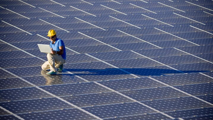 Engineer on top of solar panels