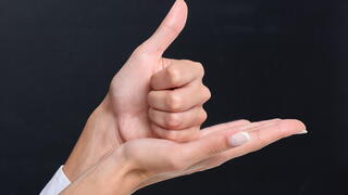Hands conveying "help" in sign language