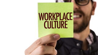 Image of man holding up a sticky note that says "Workplace Culture"