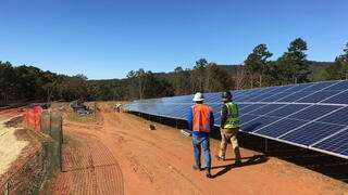 Photo of workers installing solar panels