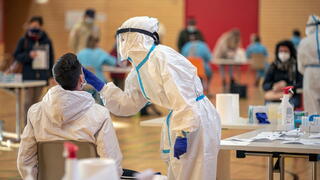 Image of healthcare worker administering Covid test