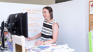 Photo of a woman in an office using a computer