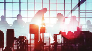 Silhouette of people working together in an office