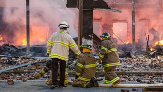 Image of firefighters in front of fire