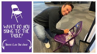 Reno City Manager Doug Thornley signs symbolic purple chair.