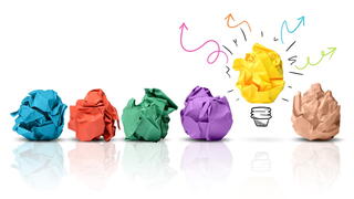Image of balls of paper with one as a lightbulb
