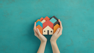Image of hands holding houses
