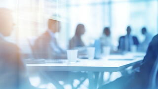 Image of people at a conference room table