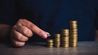 Man stacking coins