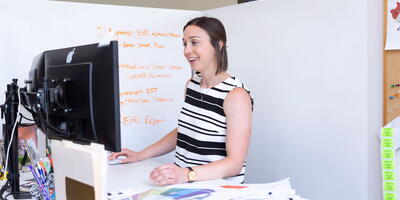 Photo of a woman in an office using a computer